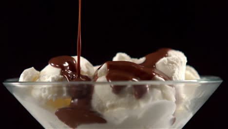 chocolate sauce pouring on ice cream