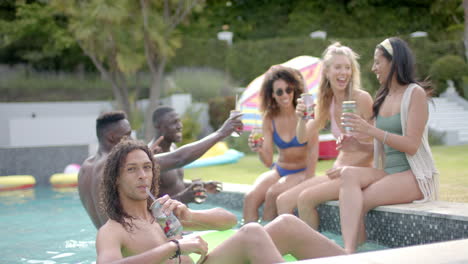 diverse young adults enjoy a pool party outdoors