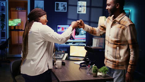 Show-host-and-guest-arriving-in-studio-to-record-podcast-with-professional-equipment