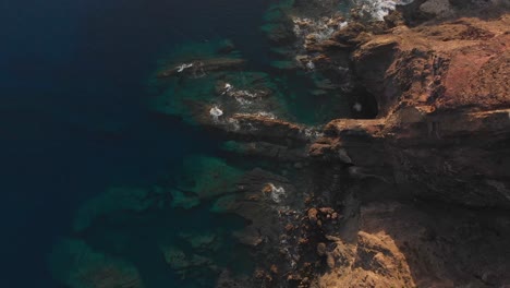 Aerial-top-down-shot-Island-Seashore-translucent-Atlantic-Water,-Porto-Santo-Island