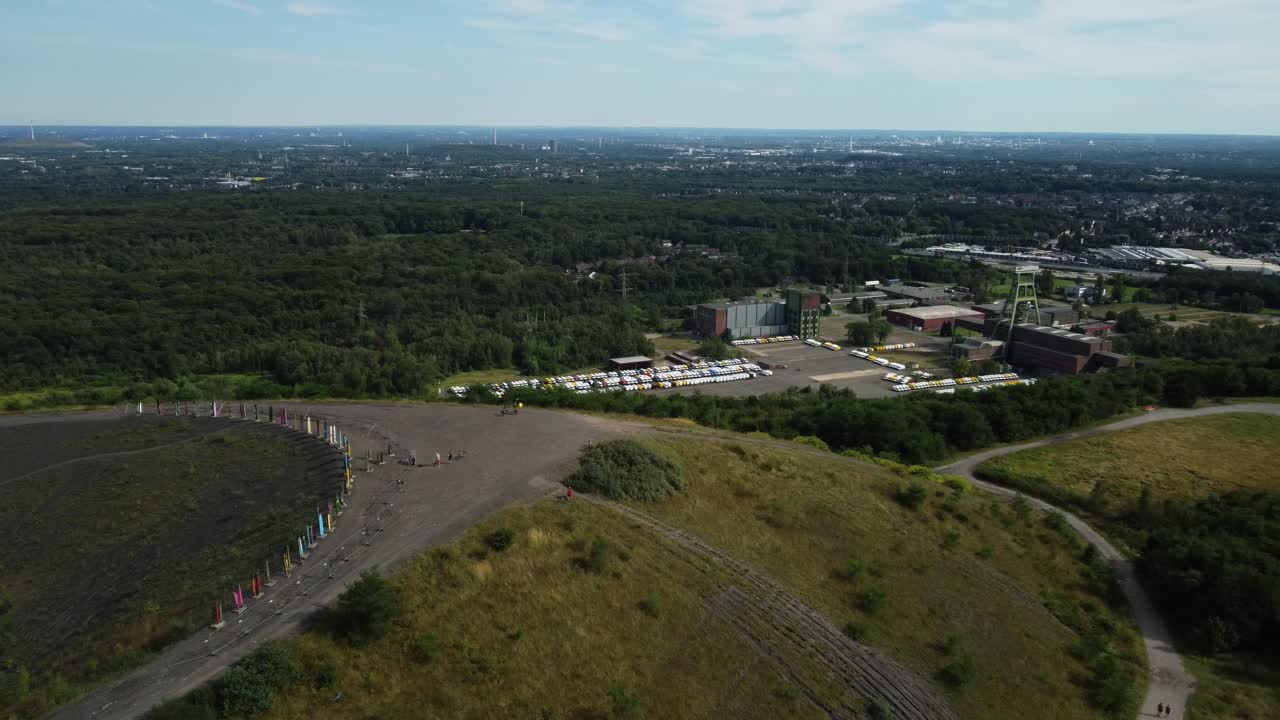 Aerial view of a former mine with colorful flags on a hill