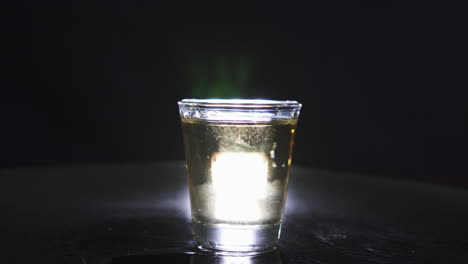 silhouette of a shot glass filled with whiskey