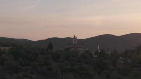 buddhist temple captured by drone in majestic mountain valley aerial footage at golden hour sunrise