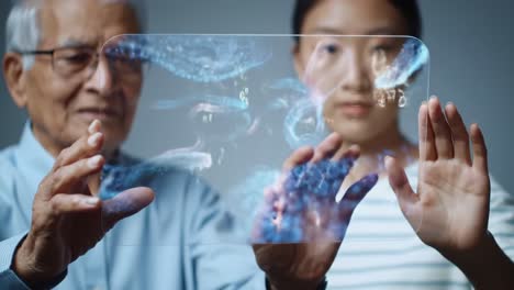 intergenerational interaction: an elderly man and a young woman explore digital possibilities through a transparent interface with visual data representations
