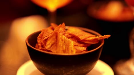 chips and cocktail in a warm setting