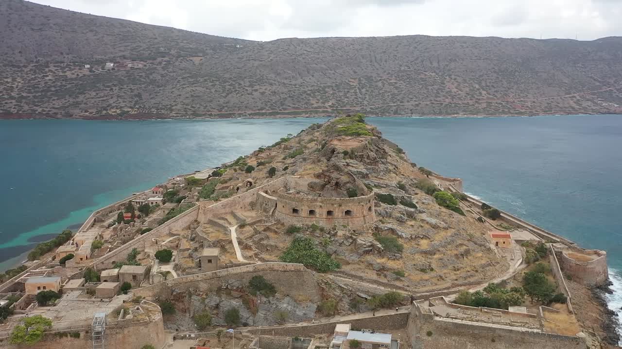 Take a journey with the drone as it flies towards the ancient forts on a remote island, with the mountain range as the backdrop