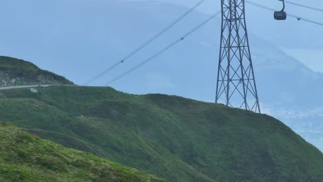 cable cars transporting passengers up and down mountain slopes, aerial