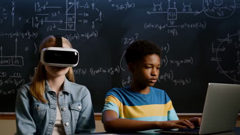 children learning with virtual reality and laptops in a classroom