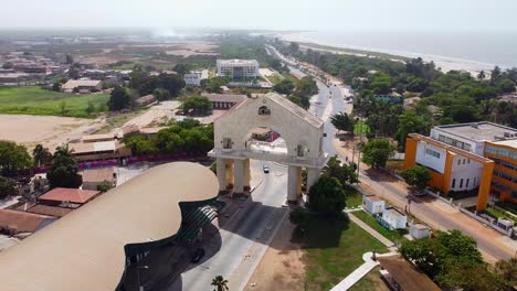 large archway entrance arch 22 at front of banjul gambia with ocean coast on side