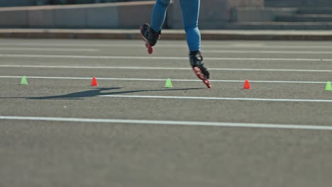 spinning around on roller skates, the roller goes around the cones and turns around itself. professional elements in roller sports, training. 4k, 10bit, prores