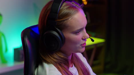 young woman gamer wearing headset