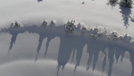 Pohorje-mountains-in-Slovenia-with-with-Kope-resort-track-below-covered-in-heavy-snow,-Aerial-pan-right-shot