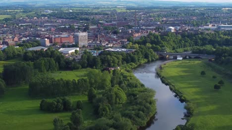 drone perspective of river eden running through rickerby park and carlisle city centre