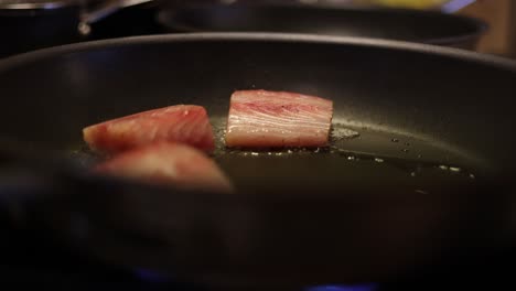 cooking mahi mahi fish on a fry pan