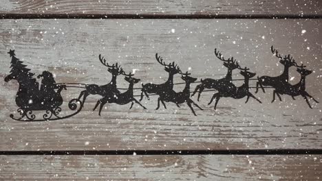 animation of silhouette of santa claus in sleigh being pulled by reindeer on wooden rustic backgroun