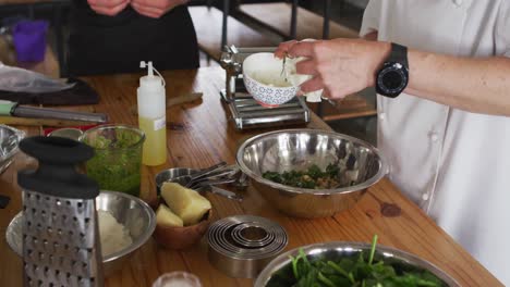 caucasian female chef teaching diverse group