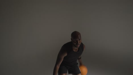 Studio-Action-Shot-Of-Male-Basketball-Player-Dribbling-Ball-And-Shooting-In-Real-Time