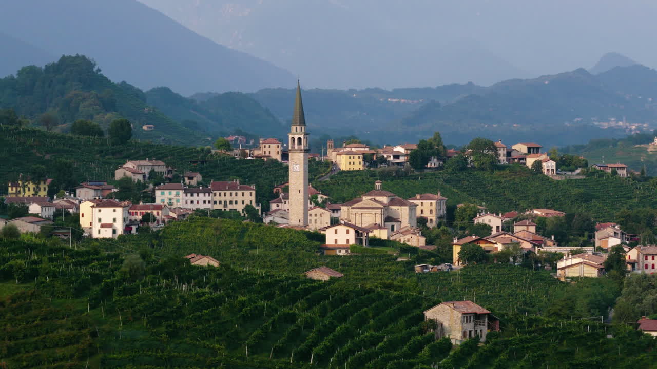 The Bell Tower Of Guia Village In The Prosecco Wine Region Of Valdobbiadene In The Province Of Treviso, Italy. Aerial Shot