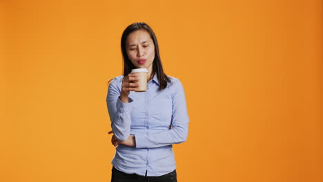 filipino person savouring cup of coffee in studio