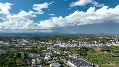 Montpellier-modern-district-and-vegetation-sunny-day-aerial-view