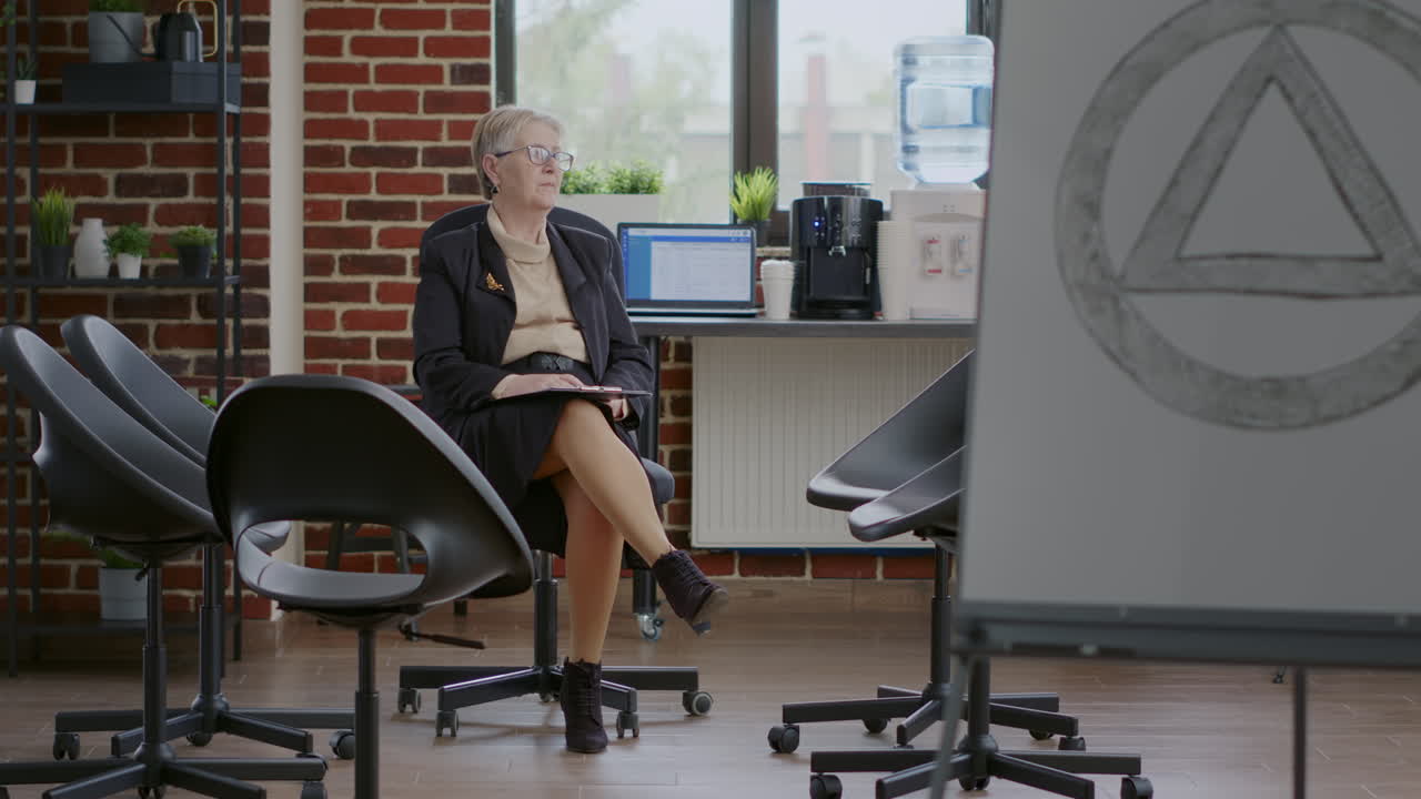 Woman psychiatrist waiting on people to attend aa group therapy meeting