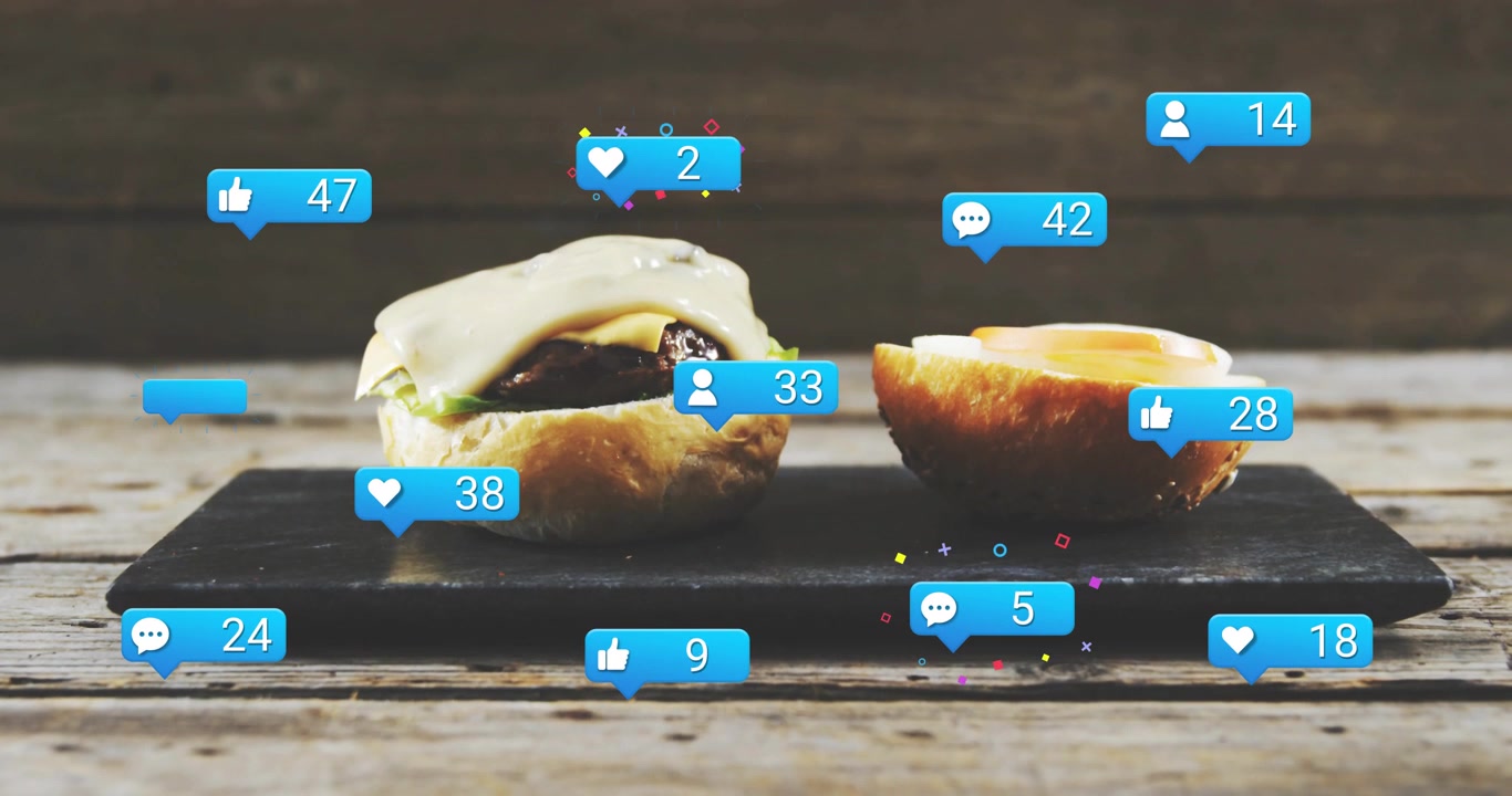 Vertical video: Dripping sauce from top, two buns on slate attracting blue icons with rising counts