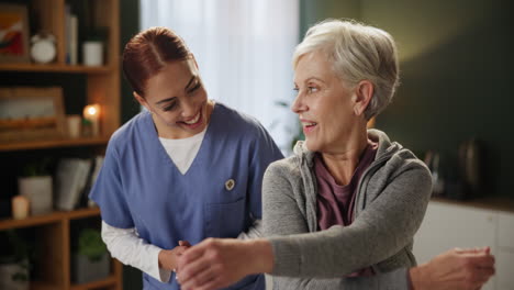 physical therapist helping senior woman with arm stretches