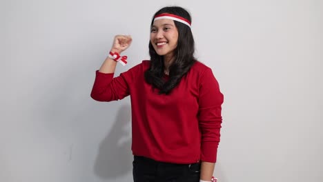 asian woman giving salute to sideways, celebrate indonesian independence day on 17 august isolated over white background