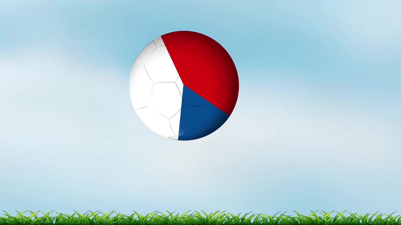 A soccer ball with national flag colors bounces across green grass under blue sky.