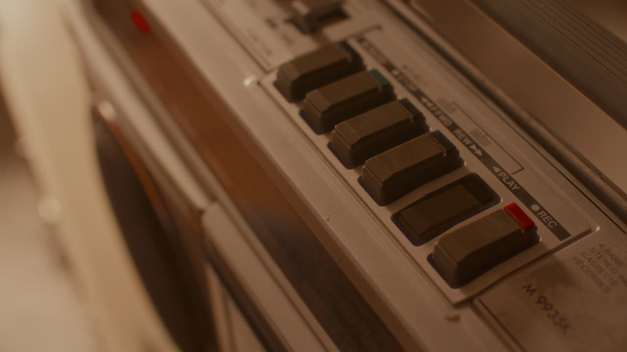 Hand Loading Cassette Tape and Pressing Play Button on Retro Boombox