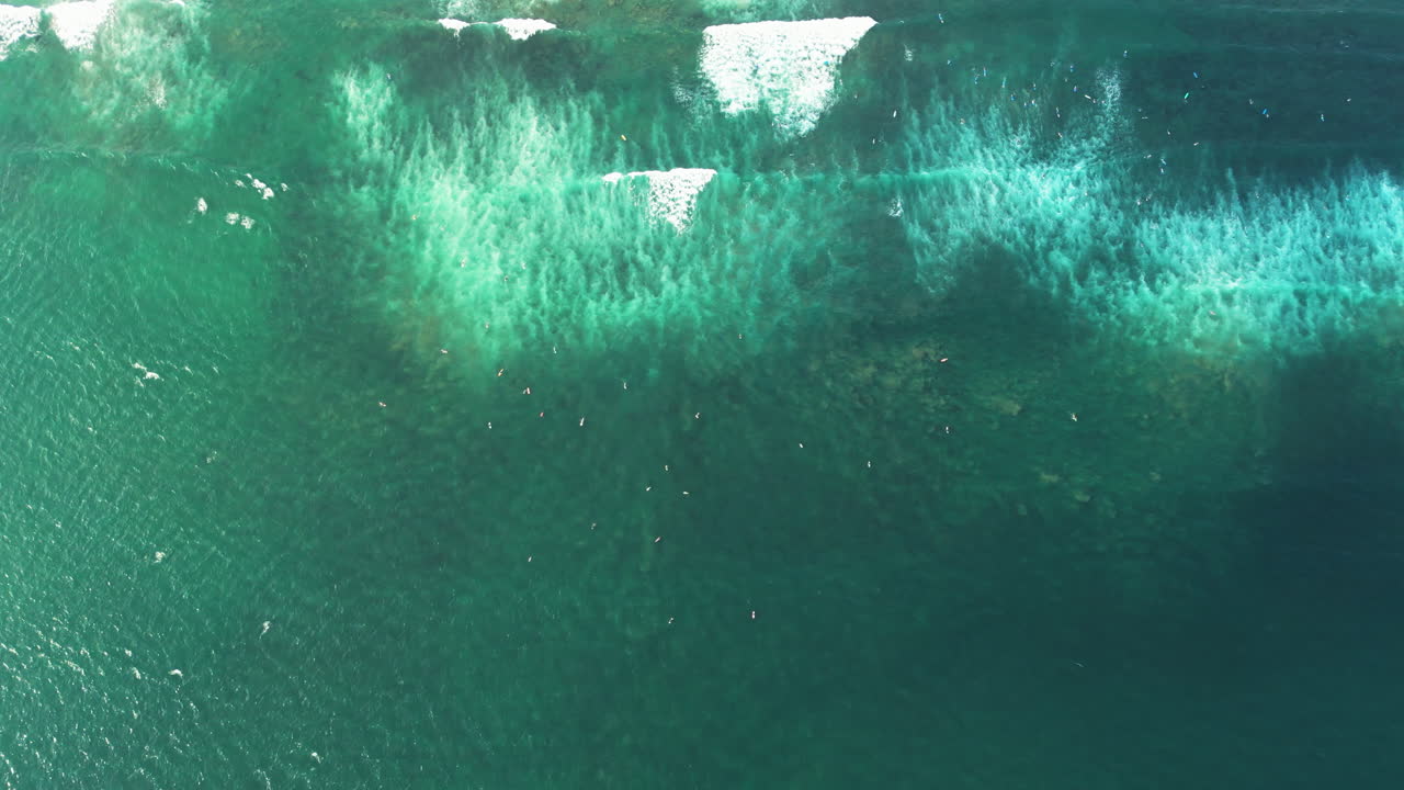 Aerial of surfers in the ocean off Canggu and Batu Bolong on Bali, Indonesia