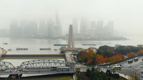 busy traffic at the waibaidu bridge, near the monument to the people's heroes in shanghai