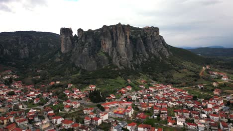 aerial approach to kalambaka city and meteora rocks in background, scenic hill town