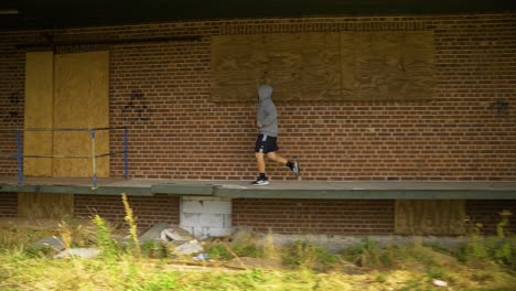 a man including running as part of his fitness routine - tracking shot