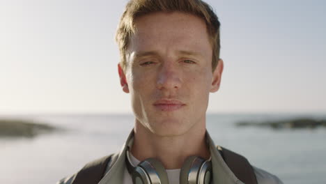 portrait of handsome young man looking thoughtful pensive on seaside background