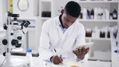 a handsome young male scientist making notes