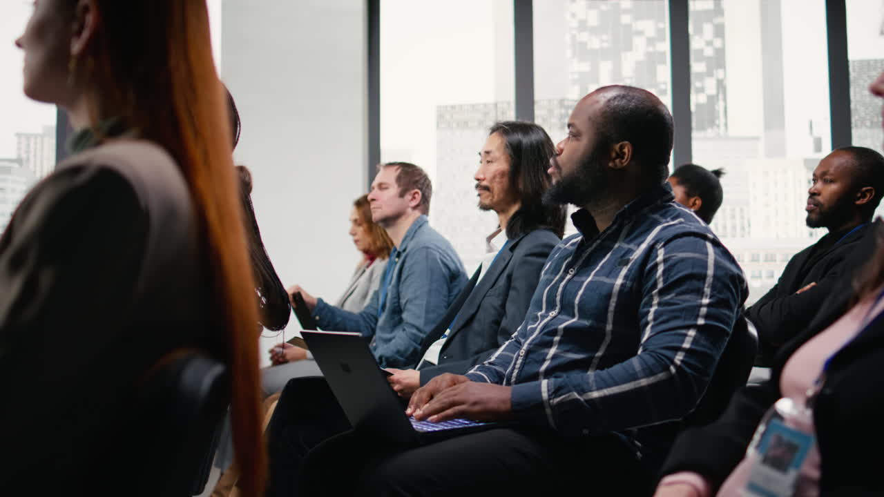 Black businessman takes notes on laptop at professional summit