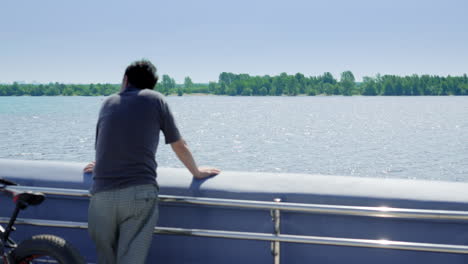 man looking at river landscape