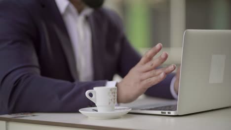 Businessman-working-with-laptop-computer-in-cafe