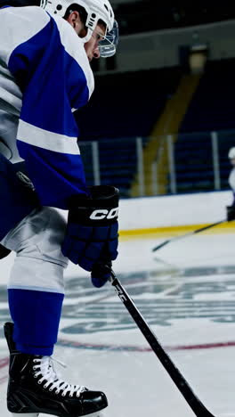 ice hockey player skating and practicing on r rink
