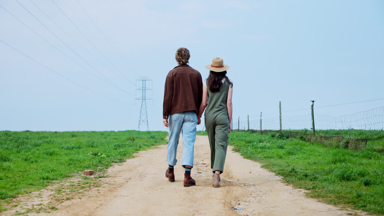 Couple Walking Hand-in-Hand on a Country Road