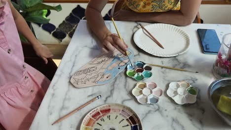 mother and daughter painting ceramic art project