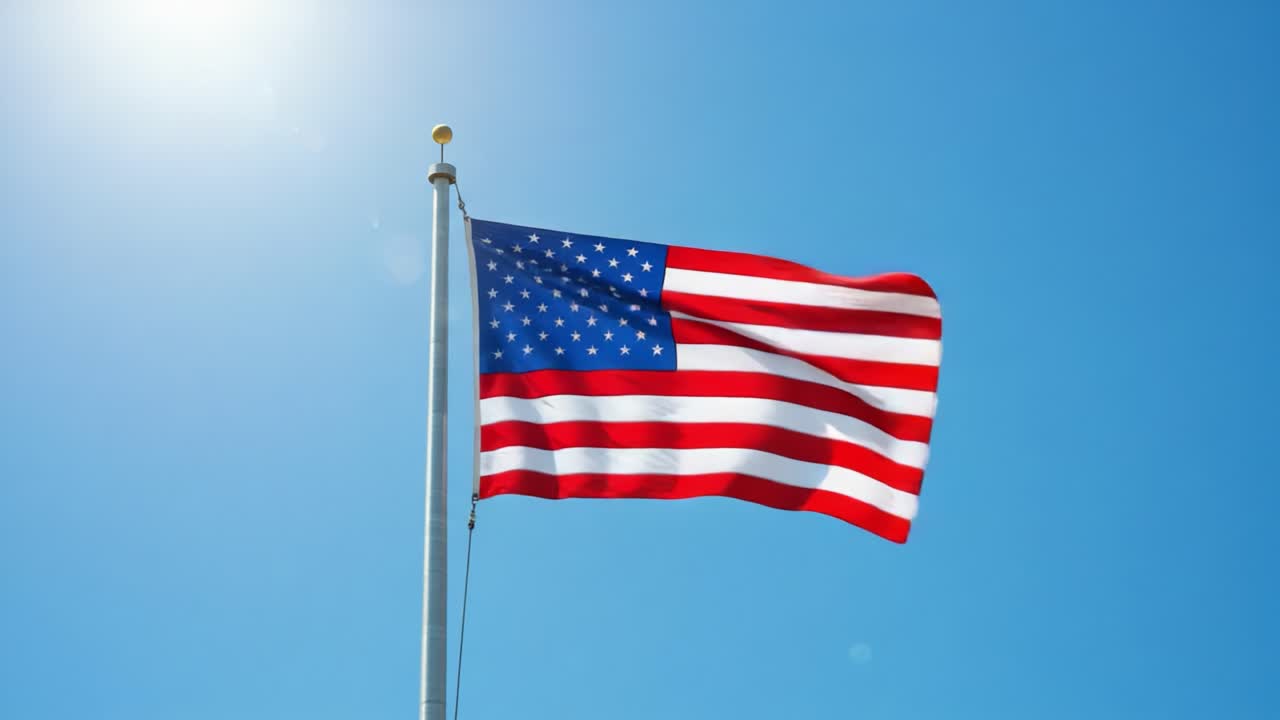 Captivating Display of a Flag Waving Under a Clear Blue Sky: An Inspiring Symbol of Patriotism and Freedom Shining in the Radiant Sunlight