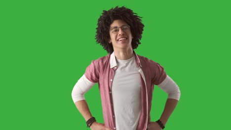 happy man with curly hair over green background