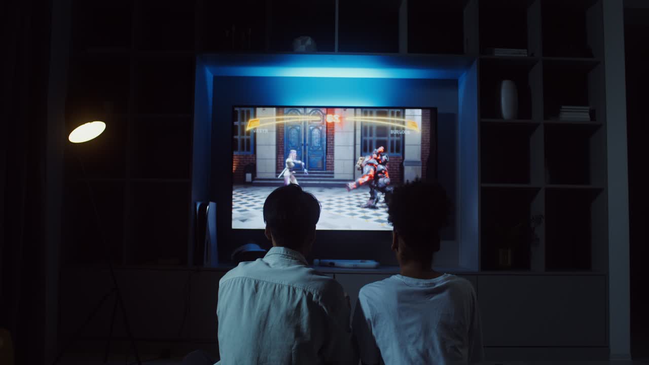 Two people playing a video game on TV