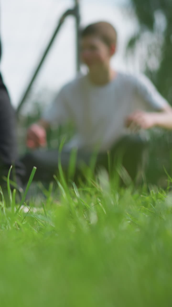 A close-up of a leg kicking a soccer ball into the goalpost, the goalkeeper, positioned in the background, misses the save