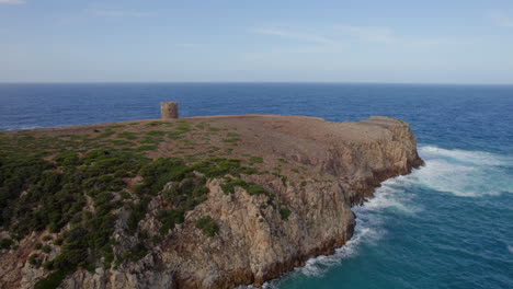 Flying-towards-the-famous-Torre-di-Cala-Domestica-on-the-island-of-Sardinia-on-a-day-with-beautiful-colors