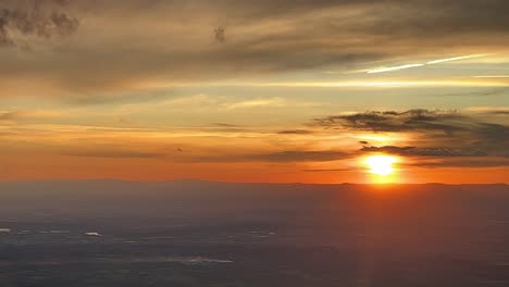 Stunning-colorful-sunset-from-above:-a-pilot’s-perspective-while-flying-westbound-approaching-to-Madrid-airport,-Spain