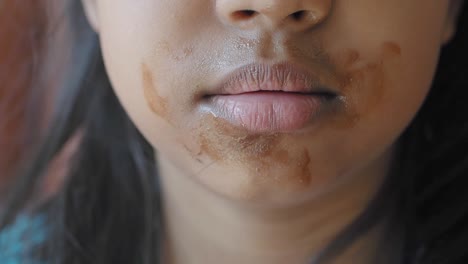 child with chocolate on face