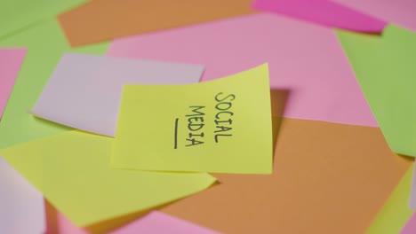 business concept of revolving sticky notes with social media written on top note 1